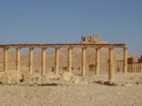 A stone pillars in a desert

Description automatically generated